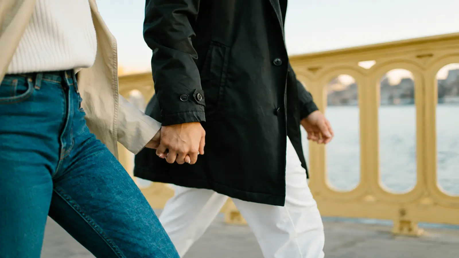 Couple holding hands while walking together on a trip for their 10th wedding anniversary celebration