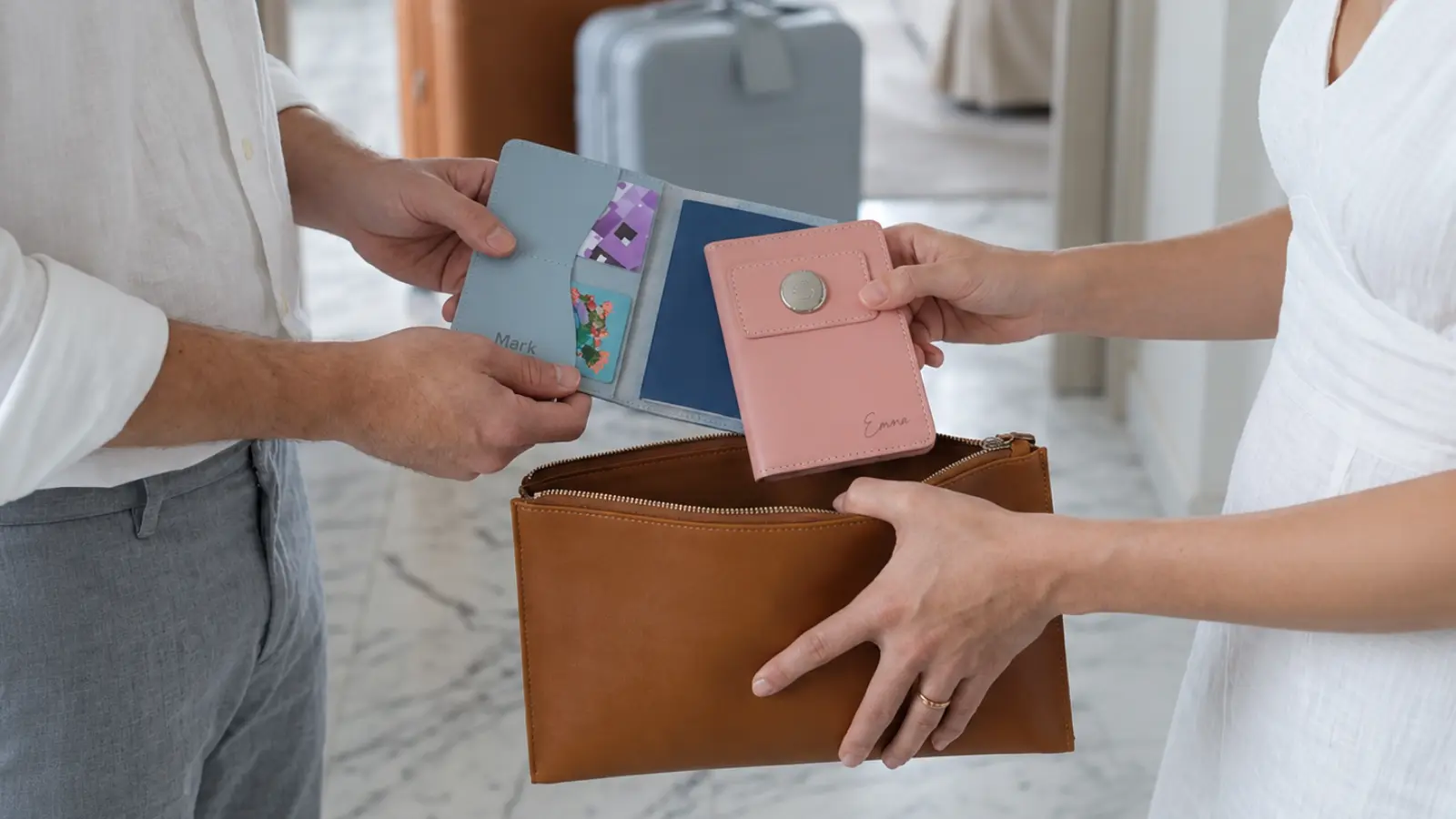 Couple holding personalized leather travel accessories, illustrating practical leather gift ideas for celebrating a third wedding anniversary together