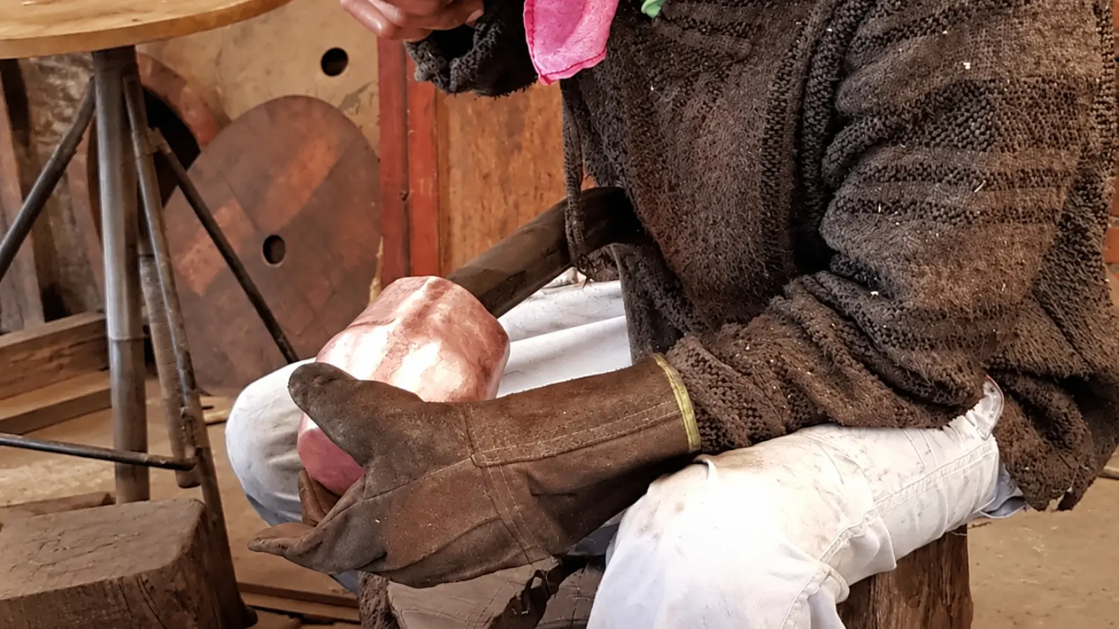 Artisan shaping a handcrafted copper vessel as a traditional 7th wedding anniversary gift