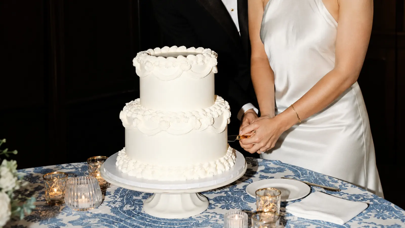 Bride and groom cutting their wedding cake