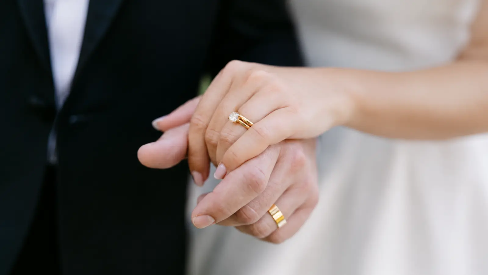 Couple hands displaying wedding rings