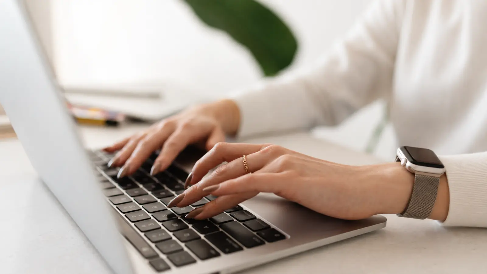 Bride planning wedding details online on a laptop at home