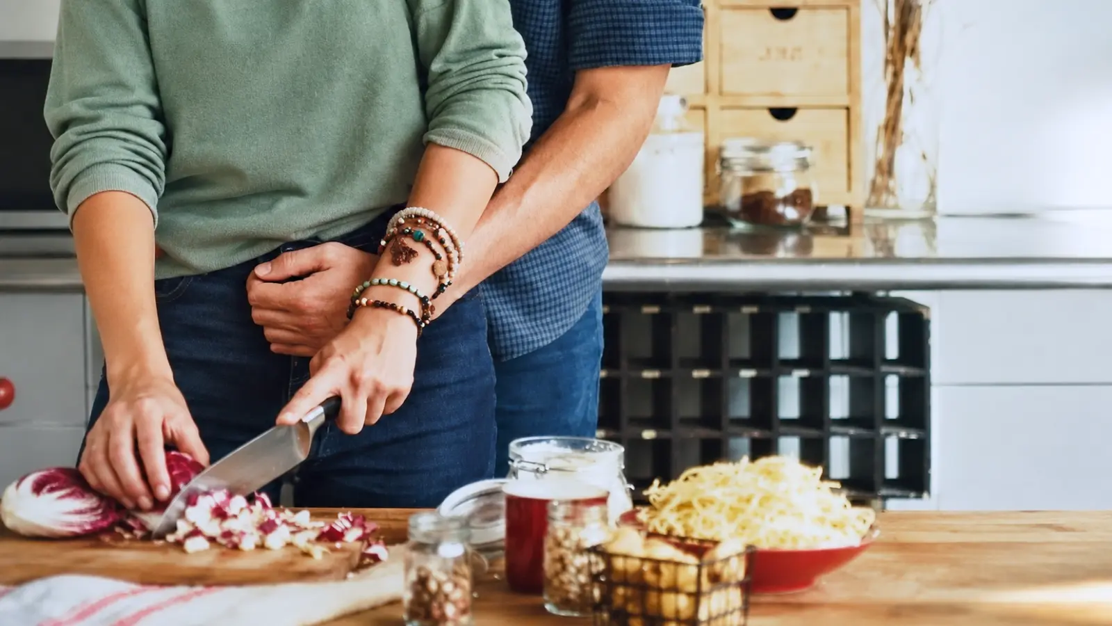 Couple cooking together at home as a shared experience for their 11th wedding anniversary