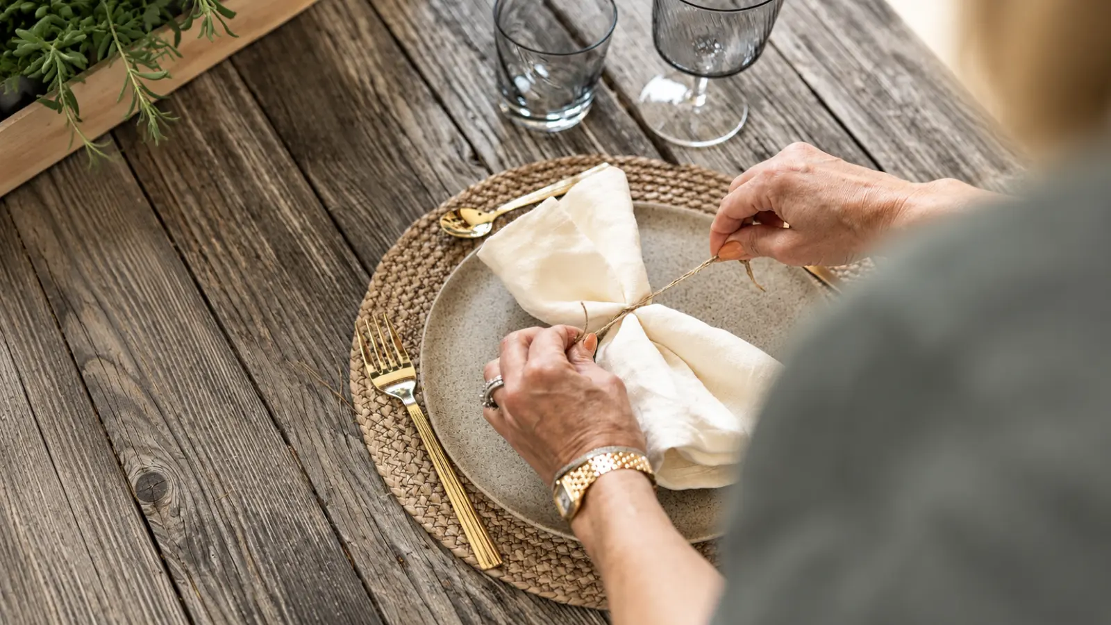 Linen napkin being arranged on a table as a 12th wedding anniversary gift and celebration idea
