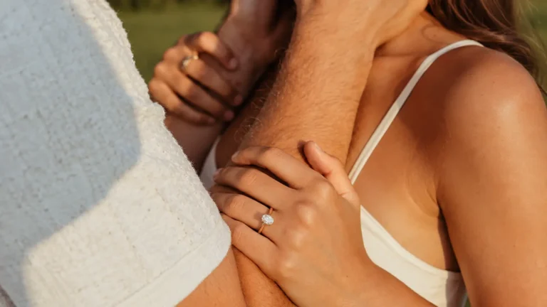 Couple embracing with an engagement ring visible while celebrating their 13th wedding anniversary 13th Wedding Anniversary Gift: Lace Ideas, Meaning and Modern Alternatives