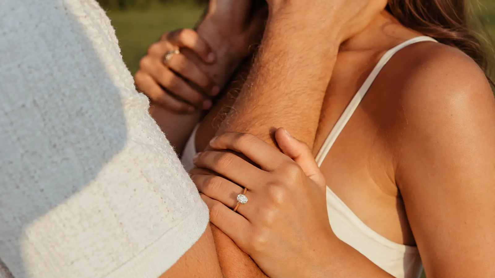 Couple embracing with an engagement ring visible while celebrating their 13th wedding anniversary 13th Wedding Anniversary Gift: Lace Ideas, Meaning and Modern Alternatives